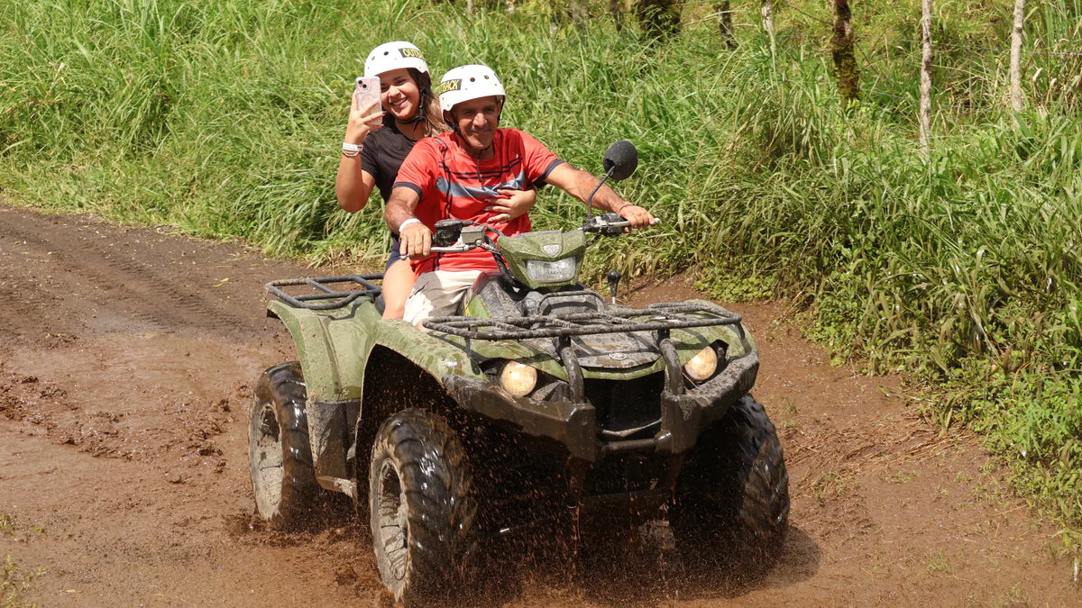 Couple riding an ATV along a rainforest trail in La Fortuna, Costa Rica