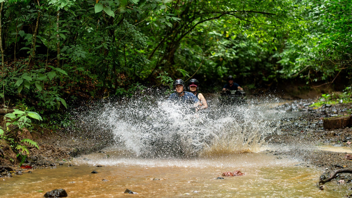 ATV crossing the river at Vista Los Sueños, Herradura