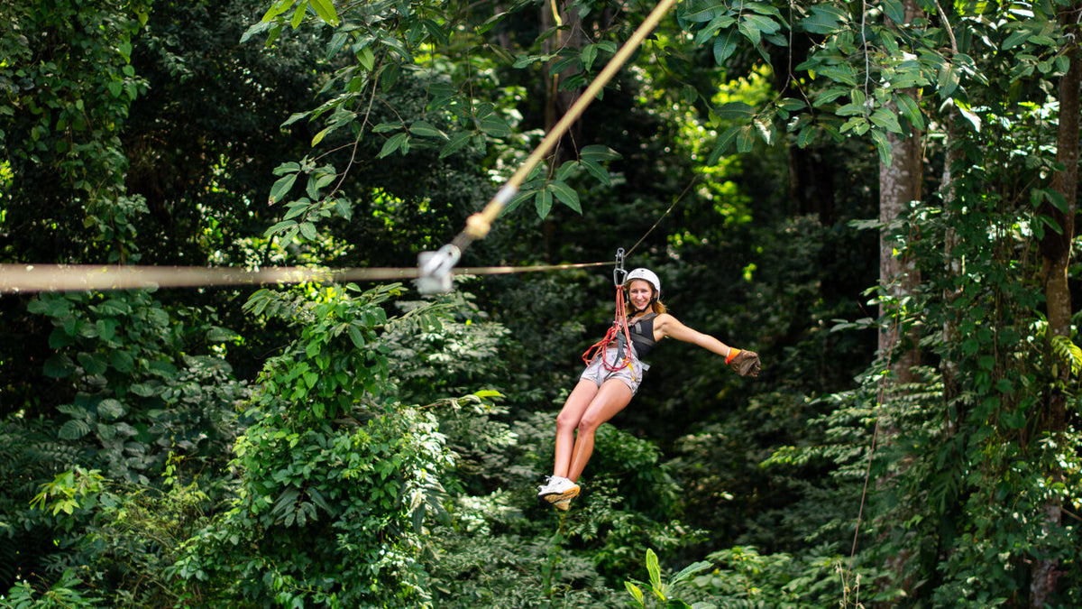 Canopy zipline rider at Vista Los Sueños Adventure Park