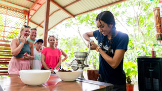 Visitors preparing chocolate at Vista Los Sueños, Herradura