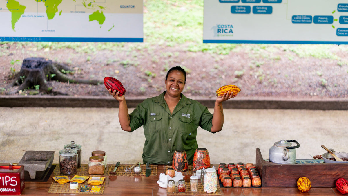 Guide presenting cacao and chocolate at Vista Los Sueños, Herradura