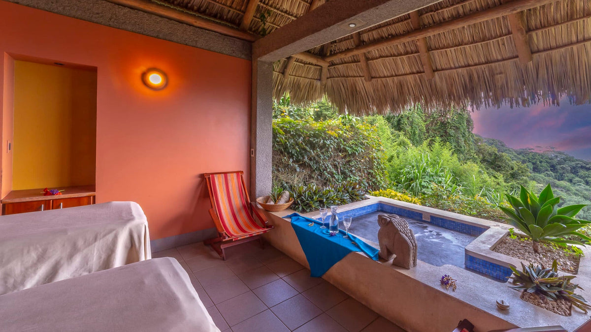 Massage beds and Jacuzzi in a treatment pavilion at Ayura Spa, Xandari