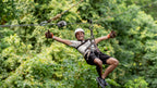 Zipline rider above the forest at Vista Los Sueños, Herradura